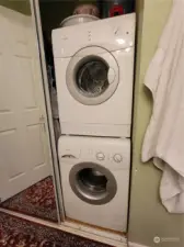 Front loaded washer and dryer located in the hall bathroom. The hot water heater is also located in this closet to the left.