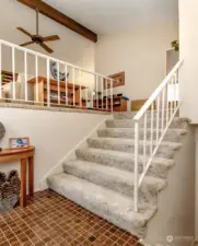 The split level entry has wide staircases and open high vaulted ceilings as you enter.