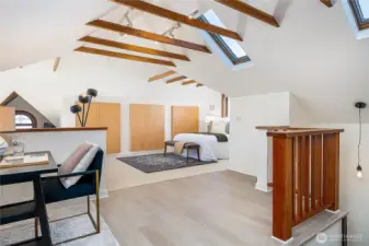 Top-floor primary suite features skylights and vaulted ceilings.