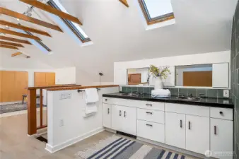 Skylights and vaulted ceilings illuminate the spa-like bathroom