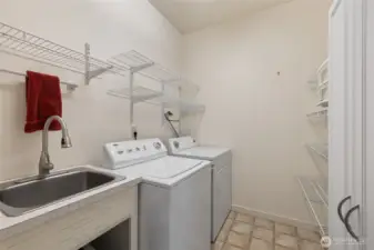 Laundry/utility room with shelving.
