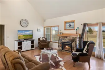 A stone fireplace with natural gas serves as the focal point of the living room.