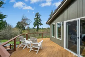 Private sitting area off the primary leads down to a hot tub just a few steps below.