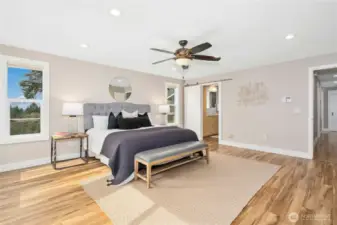 En suite bath and custom closet lie behind the sliding door.