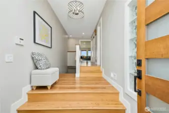 The entry offers a light-filled glimpse of what is to come.