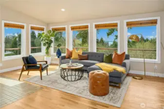 The stunning living and dining area features cathedral ceilings, abundant windows and both wood and tile flooring creating a sense of oneness with the outdoors.
