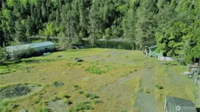 Green " casita" has power, water, a half bath, stack W/D, and could be used as a small dwelling until building.