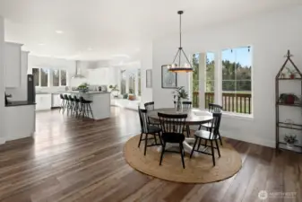 Dining table leading into the expansive custom kitchen