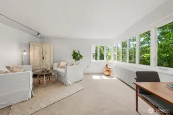 Standing at the kitchen door, to the West is a long bank of windows. A few wrap the corner to the south. Treetops through the summer, and in the winter the trees drop their leave for a territorial view.
