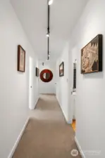 Enter the unit into the Art Gallery hallway. With track lighting it's a perfect place to display your personal collection.