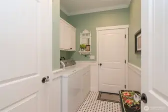 Laundry room has cabinets for storage