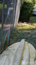 This is the property corner located just off the easement on Dakin. Neighboring fence and shed encroach the property line.
