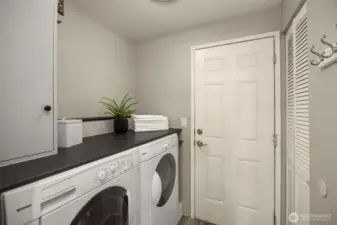 Enjoy an updated laundry room with full-size washer/dryer, a counter that makes folding effortless, and a hidden water tank for a cleaner, more organized space.