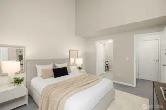 Spacious primary retreat with vaulted ceilings, direct access to 2 large closets, a sitting area, and updated bath.