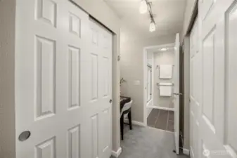 Primary suite walk-through with abundant closet storage and direct connection to updated bathroom.