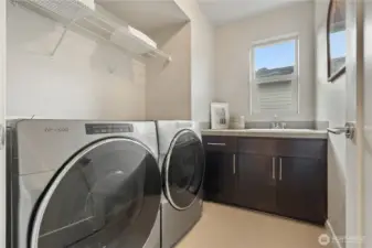 Laundry with sink and cabinets.