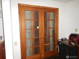 French doors leading to one of the bedrooms with slate floors