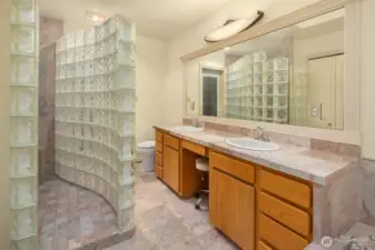 Ensuite Primary bathroom with double sinks, walk in glass block shower.