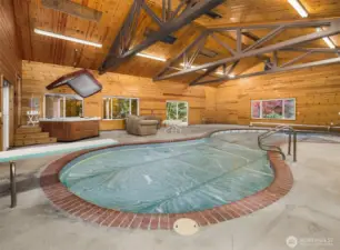 Year round entertaining space with heated pool, hot tub in warm cedar paneled room with vaulted ceilings. Multiple windows and sliding doors available to open to the outdoors.