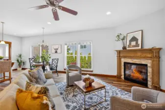 Cozy gas fireplace with wood mantle, fresh new flooring throughout.