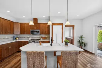 Kitchen island accommodates bar stools with counter overhang.