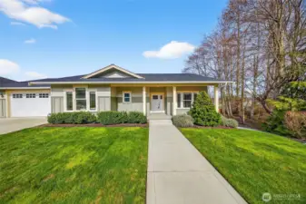 Front of home view with covered front porch and Craftsman style detailing. Greenbelt and season creek to the right of picture adds privacy and ambiance.