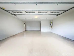 Oversized double garage with plenty of space for cars and storage or shop area.