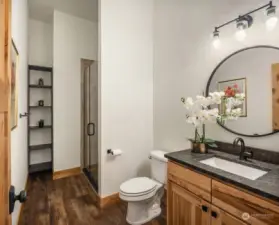 Discover another beautiful bathroom, complete with a shower and stunning cabinetry.