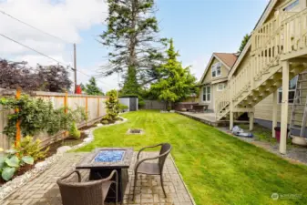 Views of full fenced yard with lovely landscape and fire pit (stays) area to enjoy.