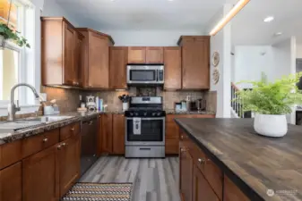 Kitchen features granite counters, stainless appliances and center island.