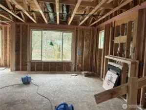 Great room shows treed view beyond.