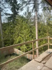 Partially completed back deck and sloped back yard.