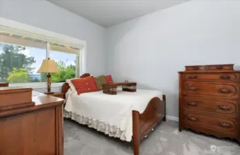 Guest bedroom one with window out to the lower patio.