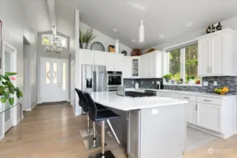 Gourmet kitchen with gas cooktop and quartz counters.