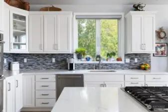 Tile backsplash and stainless appliances.