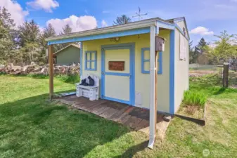 His/her/they shed in the front yard, could be an art or yoga space or...?