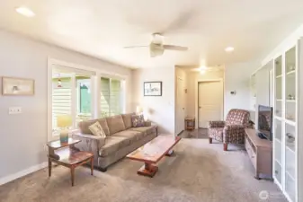 Living room with primary suite, utility room and garage entry ahead