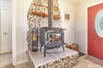 Woodstove with river rock backing