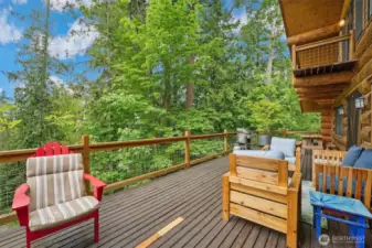 The beautiful expansive deck has water and mountain views.  Feel perched on top of the world overlooking your 2.6 acres.