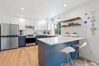 The large eat-in kitchen has a breakfast bar space for two.