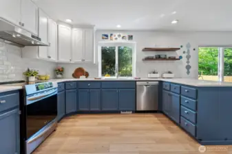 The kitchen as newer appliances, quartz countertops and a tile backsplash.