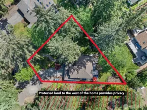 Quarter-acre lot with protected land to the west promotes privacy.