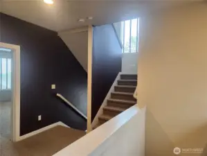 Stairs on left of photo coming from the main floor, stairs to the right of the photo lead to the roof top deck with breathtaking views.