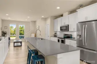 Designed for both function and style, the open-concept main level boasts quartz countertops and generous storage throughout, including a walk-in pantry you’ll love.