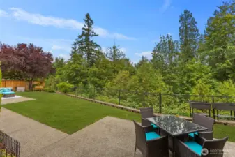 Private backyard with two patios for outdoor dining.  Also includes mature landscaping and a view of a protected greenbelt area.
