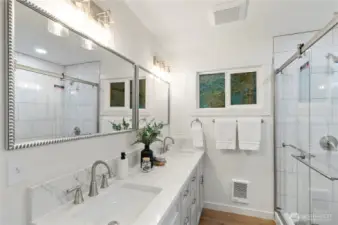 Luxurious primary bathroom with walk in closet.