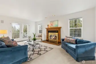 The formal living room surrounded by large, windows is a peaceful retreat from the busy household. Timeless French doors lead to the back covered patio. The handsome wood wrap fireplace has not been used by this owner.