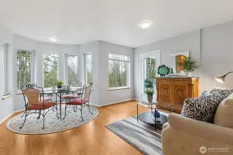 The bay eating space and great room seating area look out toward the back of the property and a serene woodland view, soon to come alive as the deciduous trees take bloom. Fantastic privacy and comfort.
