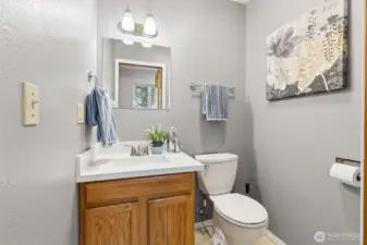 The half bath off the kitchen/utility area is a convenient location for daily use and guests.  Upgraded countertops too.