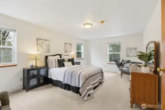 An extra wide primary suite offers plenty of space for a King size bed, and seating area plus dressers and more.